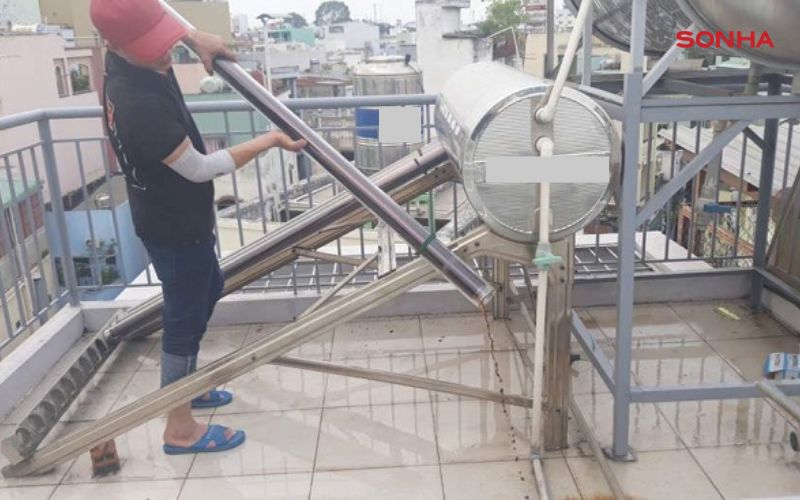 Kỹ thuật viên đang bảo trì máy nước nóng năng lượng mặt trời